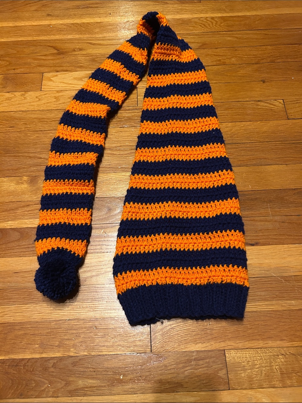 Handmade striped crochet hat in orange and navy blue with Pom Pom one size